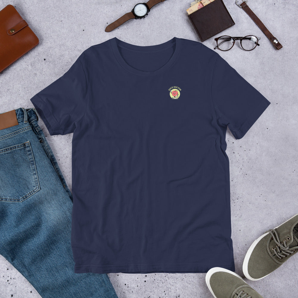Navy Juice Doctor unisex t-shirt with embroidered logo, laid flat with casual outfit accessories including jeans, sneakers, watch, and glasses. Perfect for everyday wear.
